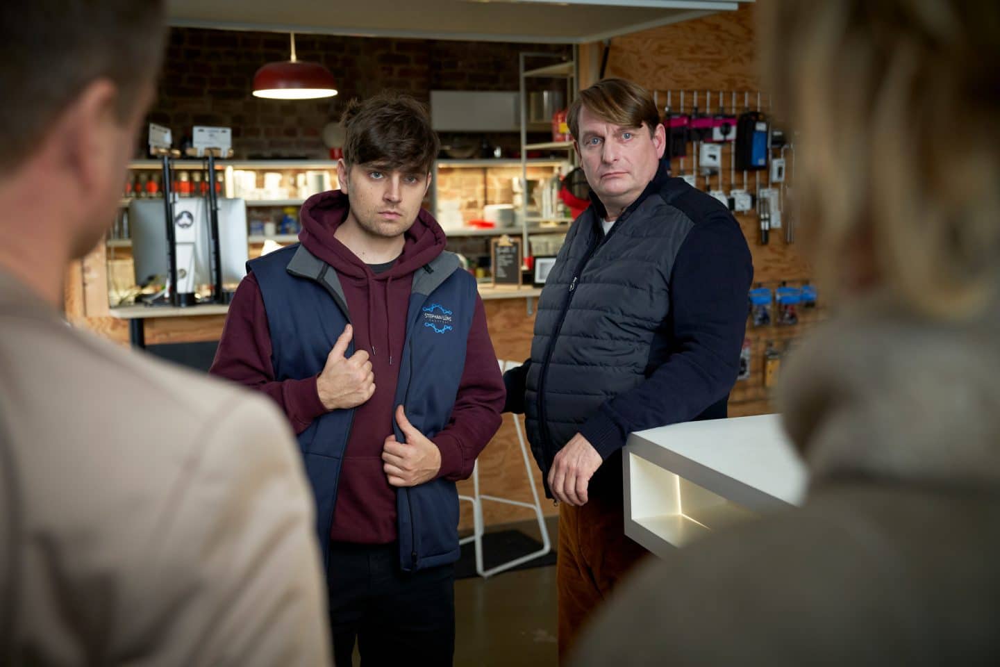 Sebastian Lürs (Markus Krojer) und Joachim Novotny (Peter Trabner) stehen vor Marie Brand (Mariele Millowitsch) und Jürgen Simmel (Hinnerk Schönemann), die man nur von hinten sieht. Dabei schauen beide sehr ungläubig drein.